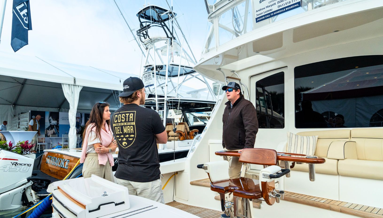 yacht broker showing a boat at a boat show